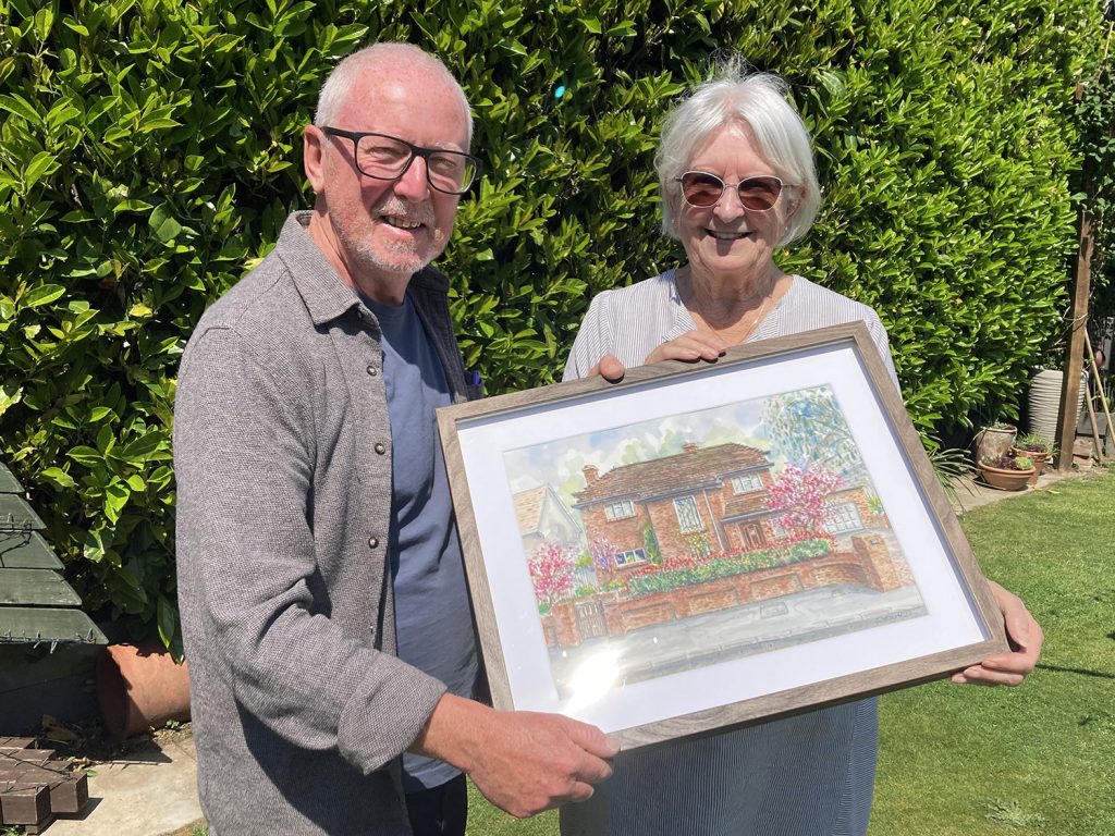 Mrs Beeston receiving her painting from Shaun Forward